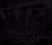 a black and white photo of a man with the words absolute cinema written below him