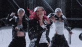 a woman with red hair is dancing with a group of dancers