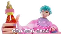 a girl with blue hair is holding a baby bottle and a bib that says baby