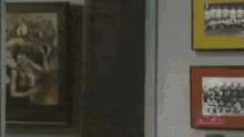 a man and woman are dancing in a living room while a woman sits on a couch .