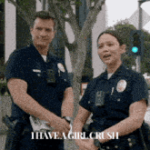 a couple of police officers standing next to each other with the words i have a girl crush on the bottom