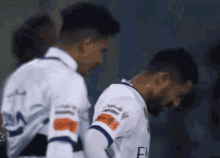 a soccer player wearing a white jersey with the letters fly on the sleeves