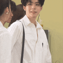 a man wearing a white shirt with the word velvet on the sleeve