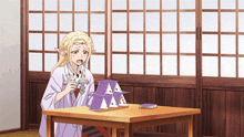 a woman sitting at a table with a stack of playing cards
