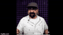 a man with a beard and glasses is wearing a hat and a white shirt