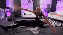 a woman is doing a plank on a man 's back
