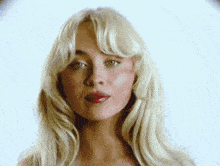 a close up of a woman 's face with blonde hair