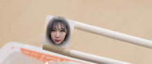 chopsticks with a picture of a woman 's face on them