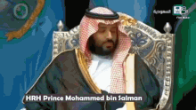 prince mohammed bin salman is sitting on a throne in front of a microphone