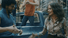 a netflix advertisement shows a man and a woman shaking hands