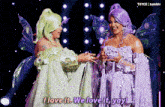 two women in fairy costumes are standing next to each other and one of them is saying i love it we love it yay