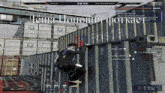 a screenshot of a video game shows a man climbing a shipping container with the word pasta on it