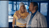 a man in a yellow shirt that says rice stands next to another man in a white coat