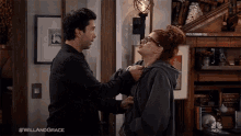 a man and a woman are standing next to each other and the hashtag #willandgrace is on the bottom