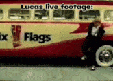 a lucas live footage of a man dancing in front of a red and yellow bus