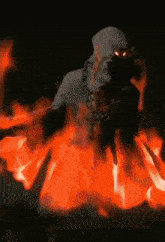 a ghost with red eyes is surrounded by fire in the dark