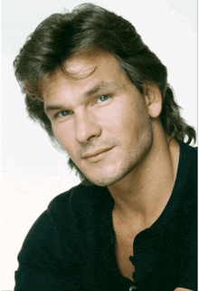 a close up of a man 's face with a black shirt