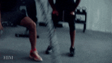 a blurred image of a person squatting with the word him visible