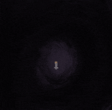 a candle in the middle of a dark tunnel