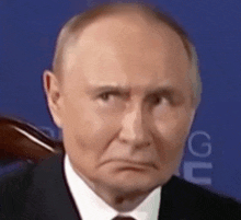 a close up of a man 's face in a suit and tie .