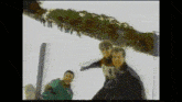 a group of people are standing in front of a tree and a sign that says ' a ' on it