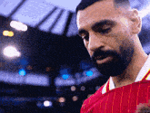a man with a beard wearing a red striped shirt