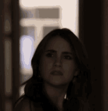 a close up of a woman 's face with a blurred background