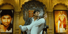 a man sitting on a throne smoking a cigarette in front of two pictures of men