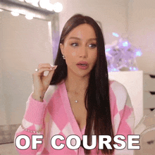 a woman in a pink and white sweater with the words of course written on the bottom