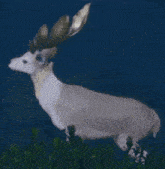 a white deer with golden antlers is standing in a field