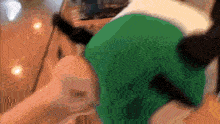 a blurry picture of a person holding a green object