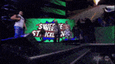 a group of wrestlers are standing in front of a green screen that says smackdown 3