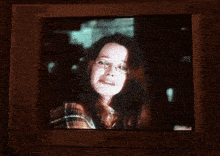 a tv screen shows a man in a wheelchair and a group of people in a living room