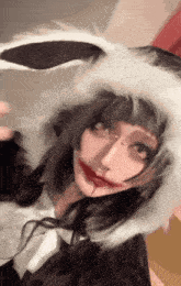 a woman in a bunny costume has a bloody mouth