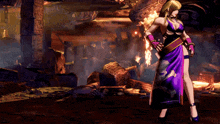 a woman in a purple dress stands in front of a fire