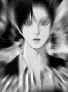 a black and white photo of a person 's face with a blurry background