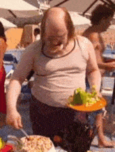 a bald man with a beard is holding a plate of food with a fork and knife .
