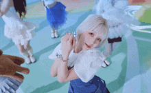 a group of young women are dancing in front of a bottle of soda