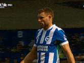 a soccer player wearing a blue and white american express jersey
