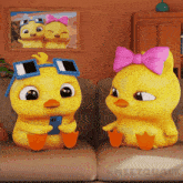 a couple of cartoon ducks are sitting on a couch and one has sunglasses on