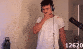 a man wearing headphones with the number 12620 on the bottom right