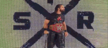 a wrestler stands in front of a screen that says sr