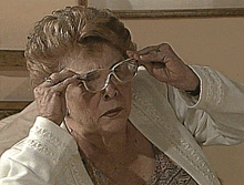 a woman wearing glasses and a white jacket