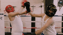 two men are boxing in a ring with neo magazin written on the wall