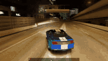 a blue gt mustang is driving down a highway