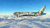 a colorful criss p airplane is flying through the sky