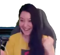 a woman with long dark hair is smiling and holding her fist up