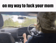 a woman is driving a car with the words on my way to fuck your mom