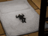 a man in a suit is laying on top of a white blanket