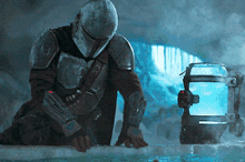 a man in armor is kneeling on a piece of ice in front of a blue container .